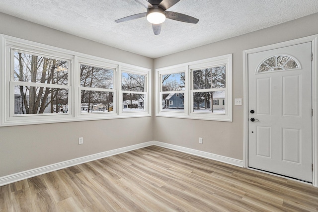 entrance foyer with a textured ceiling, light hardwood / wood-style flooring, and ceiling fan