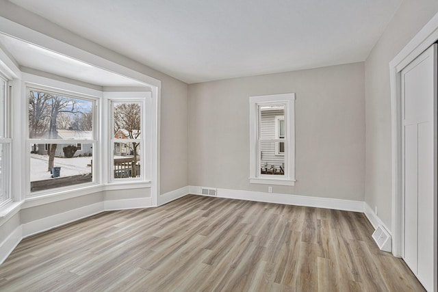 spare room featuring light hardwood / wood-style flooring