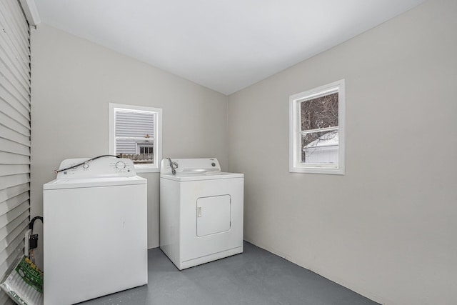 clothes washing area featuring separate washer and dryer