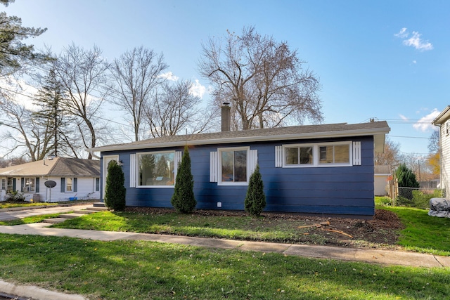 ranch-style home with a front lawn