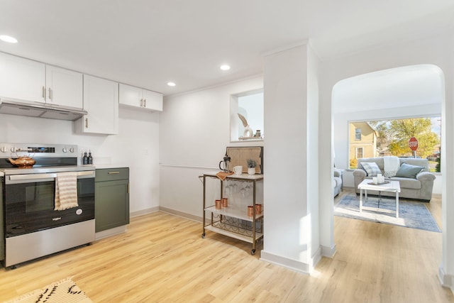 kitchen with stainless steel range with electric stovetop, light wood-type flooring, white cabinetry, and crown molding