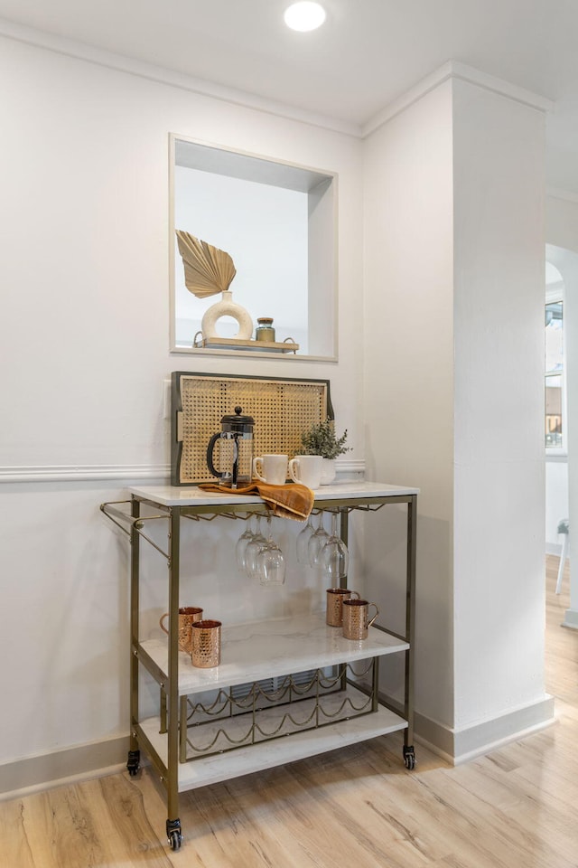 room details with hardwood / wood-style flooring and crown molding