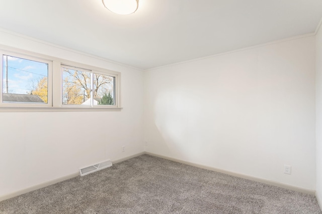 carpeted empty room featuring crown molding