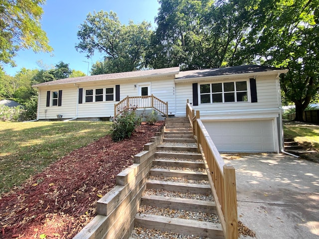 ranch-style home with a front yard and a garage