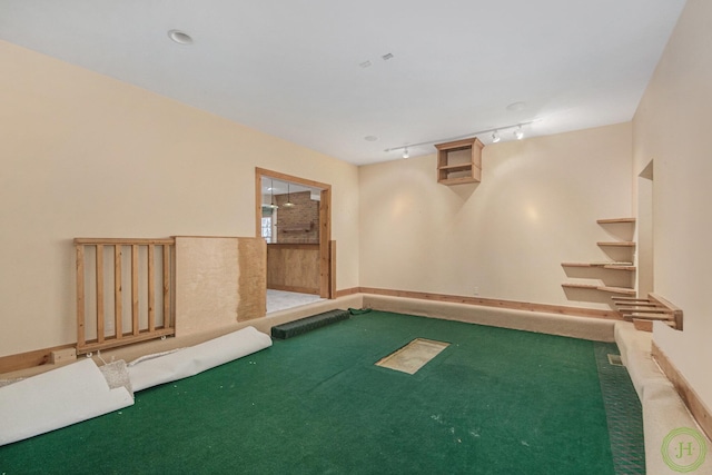 interior space featuring carpet and track lighting