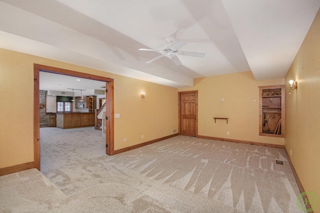 spare room featuring light carpet and ceiling fan