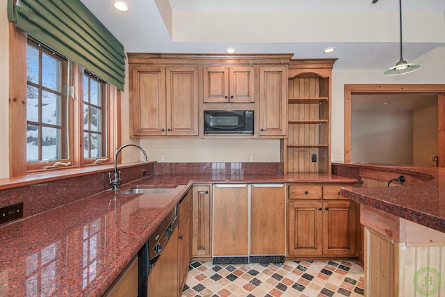 kitchen with pendant lighting, sink, dishwashing machine, dark stone countertops, and black microwave