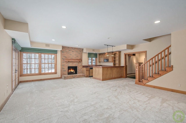 unfurnished living room featuring a brick fireplace and light carpet