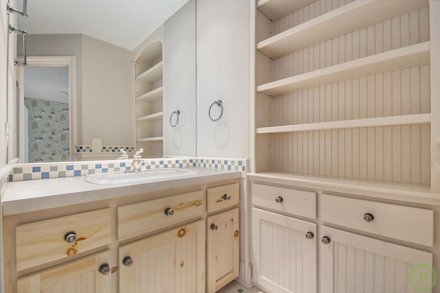 bathroom featuring vanity and backsplash