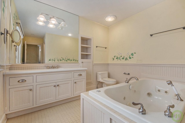 bathroom with tile patterned flooring, vanity, a bathtub, and toilet