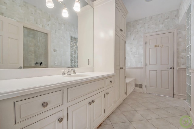 bathroom with tile patterned flooring and vanity