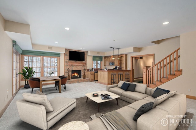 living room with a fireplace and light carpet