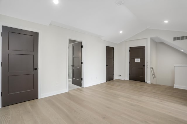 interior space featuring light hardwood / wood-style floors and lofted ceiling