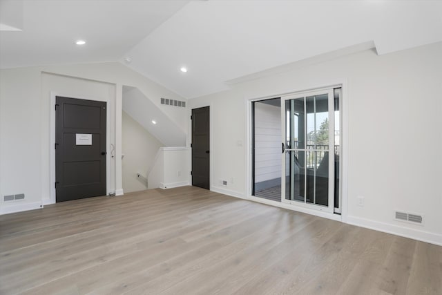 unfurnished living room featuring light hardwood / wood-style flooring and lofted ceiling