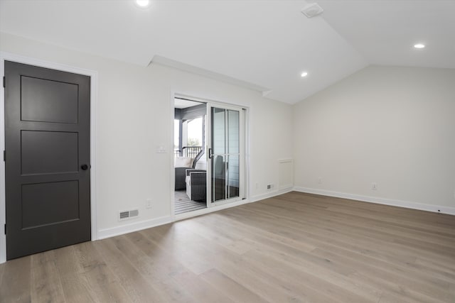 unfurnished room with lofted ceiling and light hardwood / wood-style flooring