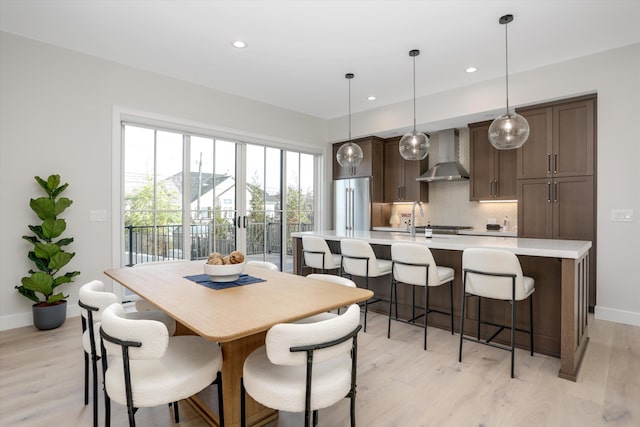 dining room featuring light hardwood / wood-style floors and sink