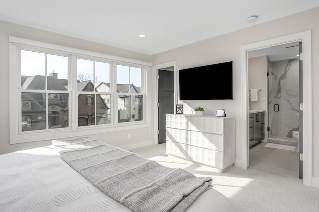 carpeted bedroom featuring ensuite bath