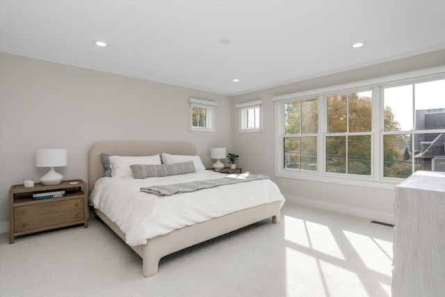 carpeted bedroom featuring multiple windows