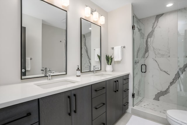 bathroom with vanity, a shower with shower door, and toilet