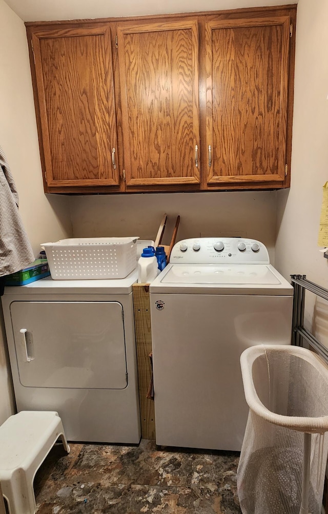 washroom with cabinets and washing machine and dryer