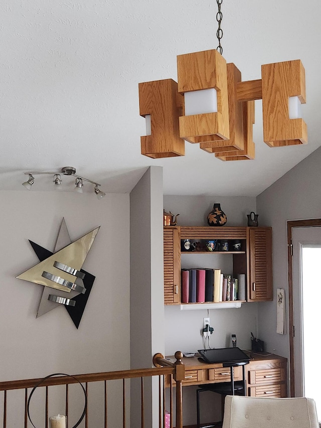 interior space featuring pendant lighting and vaulted ceiling