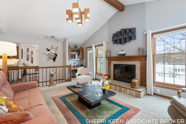 living room featuring beamed ceiling, high vaulted ceiling, carpet floors, and a tile fireplace