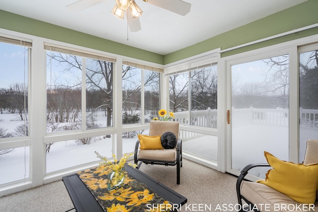 sunroom featuring ceiling fan and plenty of natural light