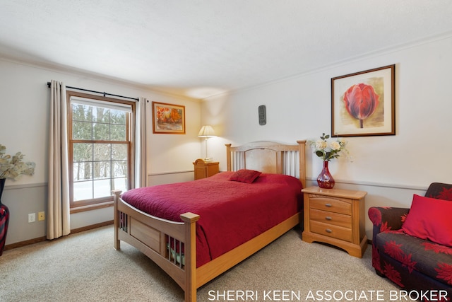 carpeted bedroom with ornamental molding