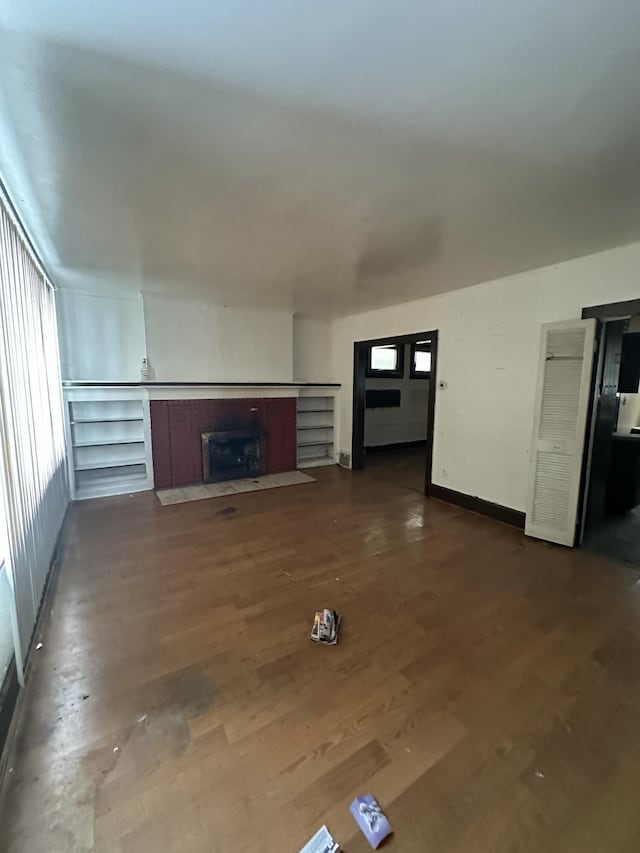 unfurnished living room featuring dark hardwood / wood-style flooring