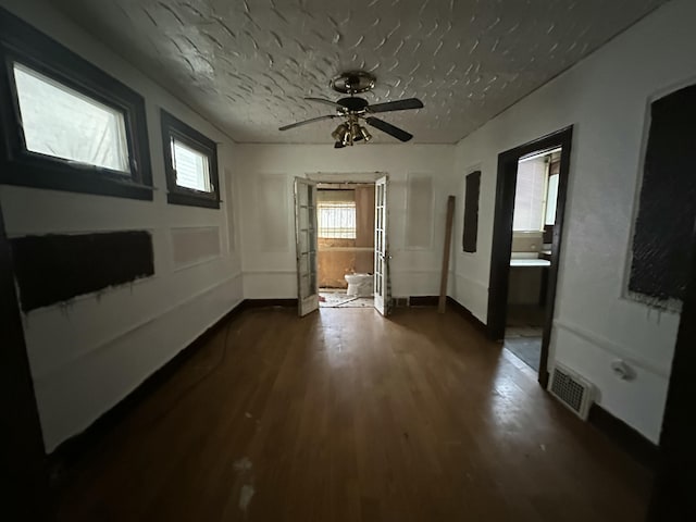 unfurnished room with dark wood-type flooring and a textured ceiling