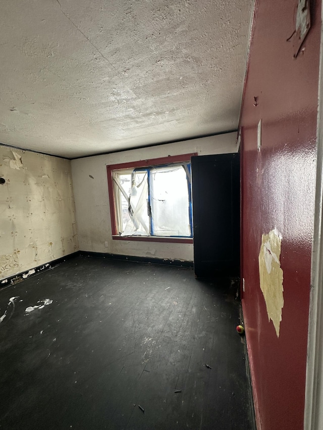 unfurnished room featuring a textured ceiling