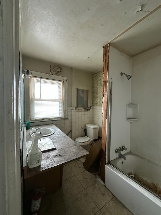 full bathroom with toilet, tile walls, tile patterned flooring, bathtub / shower combination, and vanity