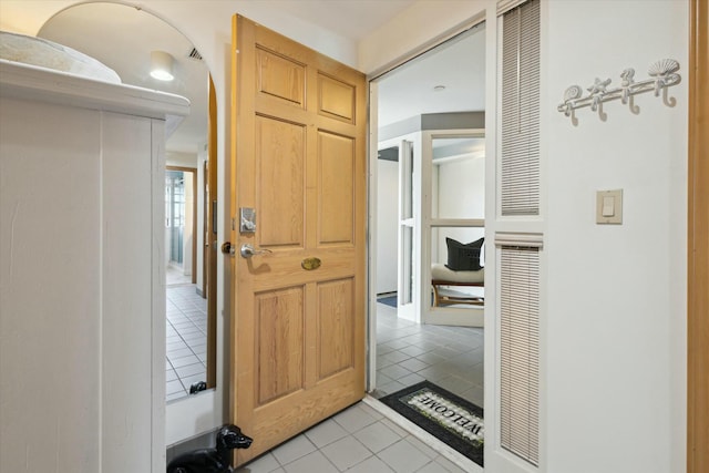 hall featuring light tile patterned floors