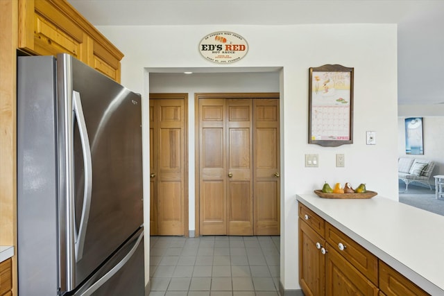 kitchen with stainless steel fridge and light tile patterned floors