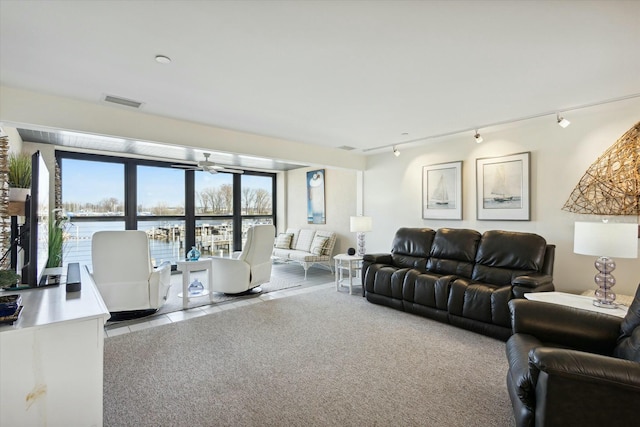 living room with ceiling fan, light carpet, and track lighting