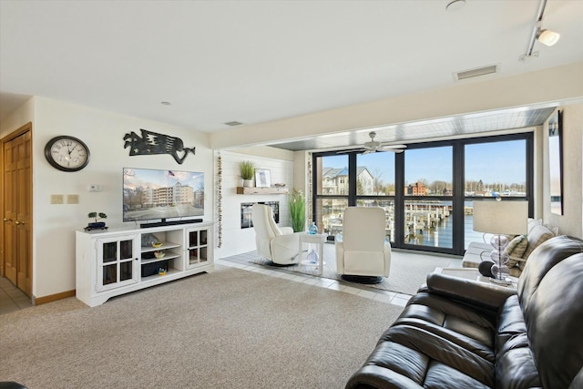 carpeted living room featuring ceiling fan and rail lighting