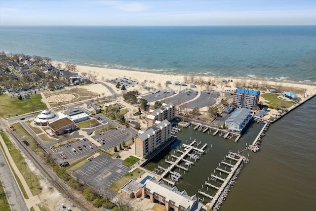 drone / aerial view with a water view and a beach view