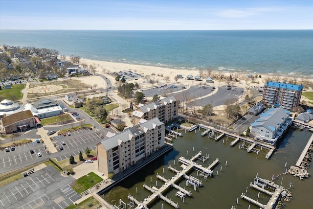 drone / aerial view featuring a water view and a view of the beach