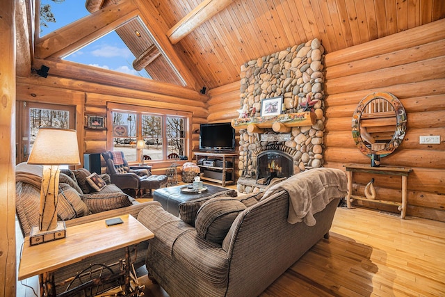 living room featuring rustic walls, high vaulted ceiling, a fireplace, and beam ceiling