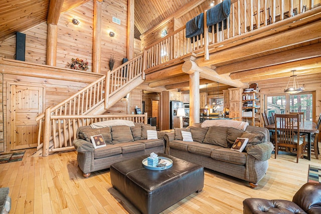 living room with beam ceiling, light hardwood / wood-style floors, wooden ceiling, and high vaulted ceiling