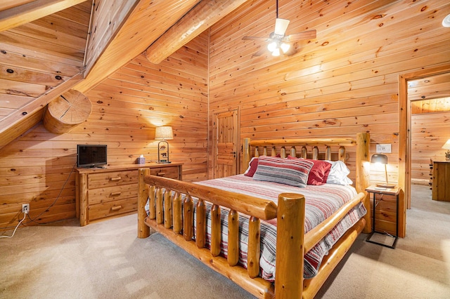 bedroom with beamed ceiling, a towering ceiling, ceiling fan, wood walls, and light colored carpet