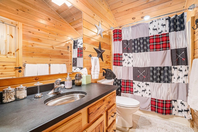 bathroom featuring vaulted ceiling, toilet, wooden walls, and vanity