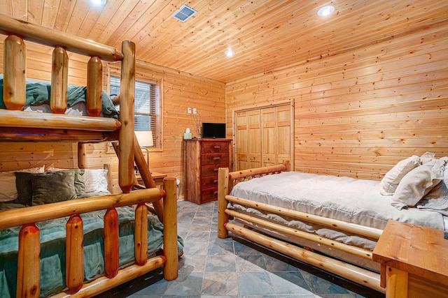 bedroom featuring wood ceiling, wooden walls, and a closet