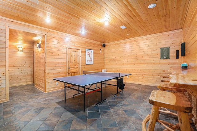 recreation room featuring wooden walls and wooden ceiling