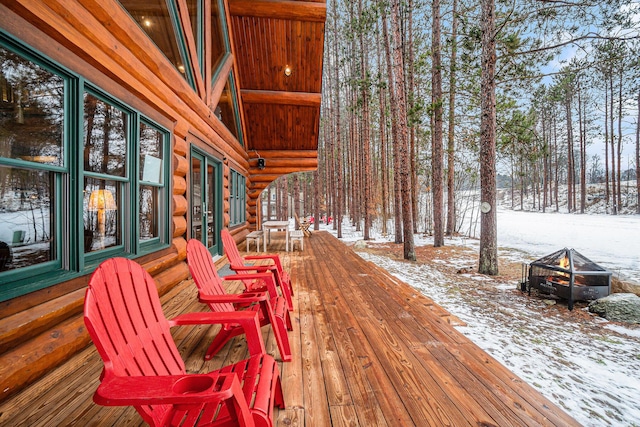 snow covered deck with an outdoor fire pit