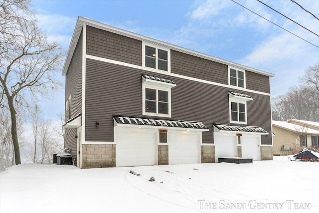 view of front of home featuring central AC and a garage