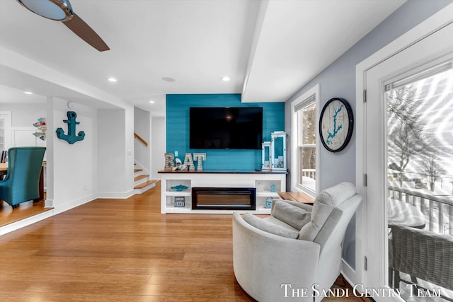 living room with ceiling fan and light hardwood / wood-style floors