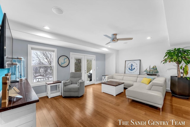 living room with ceiling fan, french doors, a healthy amount of sunlight, and wood-type flooring