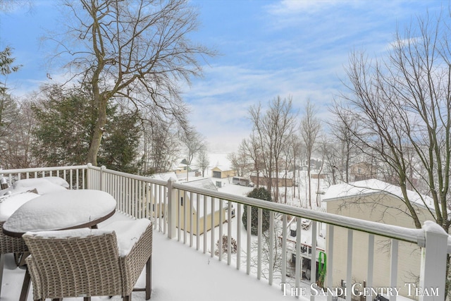 view of snow covered back of property