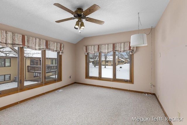 unfurnished room featuring carpet, ceiling fan, and lofted ceiling